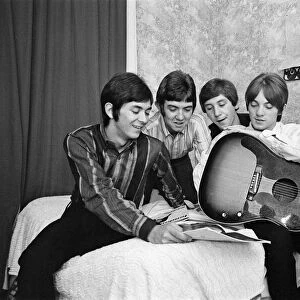 The Small Faces pop group pictured in a provincial hotel room as they watch their latest