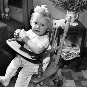 Small girl enjoying a cup of tea. August 1953 D5235-001