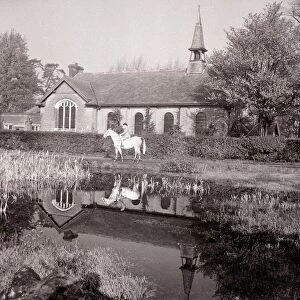 A small Methodist village church in Mill Hill Village London where a lady is out riding