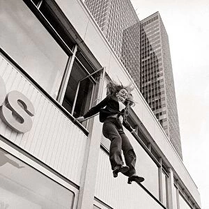 With a smile on her face stunt girl Sue Crosland plunges 30ft from a window in the Thames