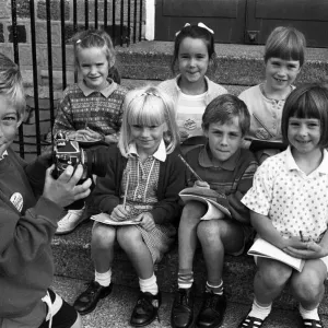Smile please! Six-year-old Adam Bedford puts his reporter colleagues Smile please! Six-year-old Adam Bedford puts his reporter colleagues