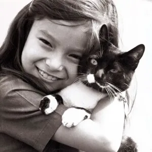 Smiling Carol Riley of Ealing collects her pet cat Cupid after he was released