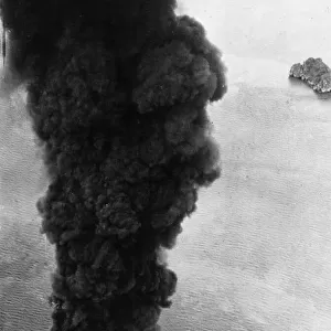 Smoke rising from a 10, 000 ton Japanese tanker which was attacked by Liberators of 159