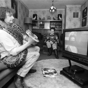 When snake lover Tony Griffiths settles down to watch TV with Monty, his pet python When snake lover Tony Griffiths settles down to watch TV with Monty, his pet python