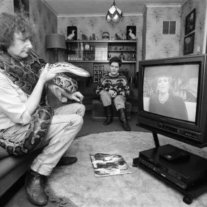 When snake lover Tony Griffiths settles down to watch TV with Monty, his pet python When snake lover Tony Griffiths settles down to watch TV with Monty, his pet python