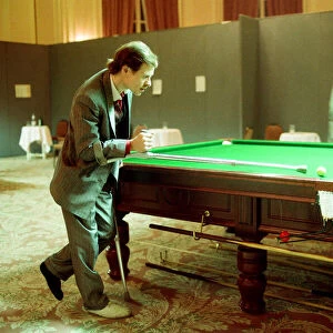 Snooker player Alex Hurricane Higgins with his foot in plaster