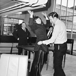 Snooker player Alex Hurricane Higgins being searched at London Airport