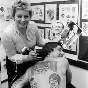 A black and white print of a man with his back tattooed
