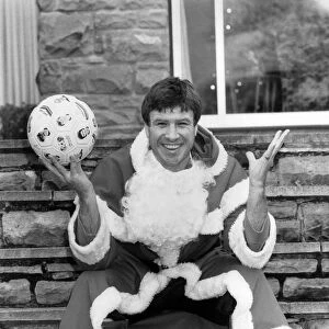 Soccer star Emlyn Hughes pictured as Santa Claus at his home in Sheffield
