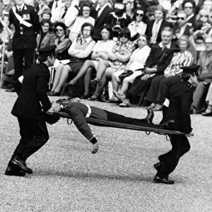 A soldier of the Scots Guard is stretchered off the parade ground during the Trooping of