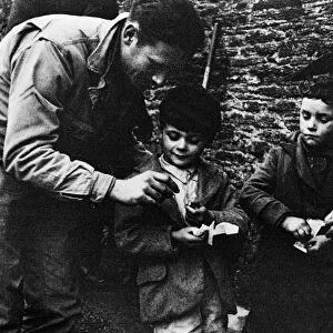 US soldier sharing chocolate with the local children of Slapton during the evacuation of