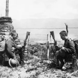 Two soldiers pay tribute by the grave of a fallen comrade on leaving the front line Two soldiers pay tribute by the grave of a fallen comrade on leaving the front line