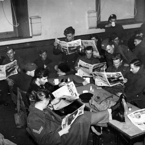 Soldiers reading the Sunday Pictorial. April 1943