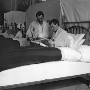 Soldiers recovering from their wounds catch up with the news at the British Women
