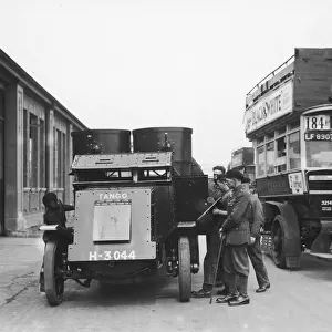 Soldiers seen here with their Austin armoured car at a bus depot