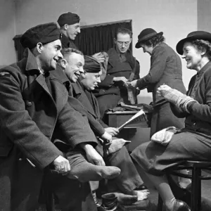 Soldiers have their socks repaired. February 1942