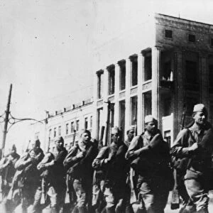 Soldiers of the Soviet Red Army marching through the streets of a townin the front zone