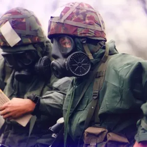 Soldiers from the T. A. wearing nuclear and biological suits and masks for an exercise Soldiers from the T. A. wearing nuclear and biological suits and masks for an exercise