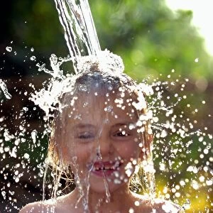 Sophie Davies (6yrs) (daughter of photographer) cools off in the hot weather with a