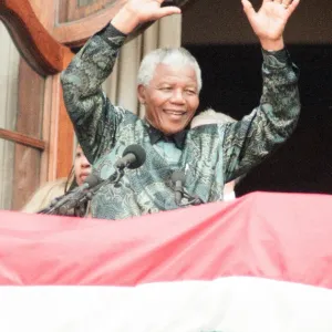 South African President Nelson Mandela waving to the crowds from the balcony of South South African President Nelson Mandela waving to the crowds from the balcony of South