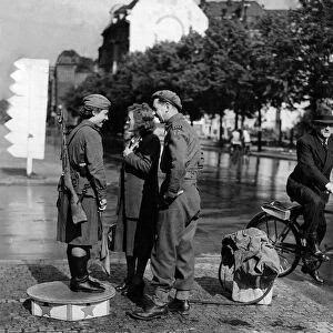 A Soviet Army girl on traffic duty in the Unter den Linden in Berlin chats with a British