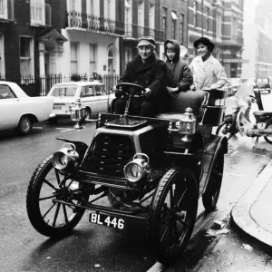Spike Milligan off for a drive in the rain in a 1901 Durkopp loaned from the Montague