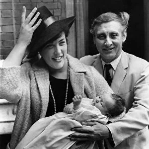 Spike Milligan and wife having hat trouble with baby Jane Fionulla after the christening
