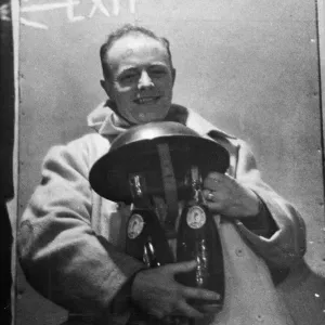 A spotter in a city area finds the safe custody of his steel helmet for his two bottles A spotter in a city area finds the safe custody of his steel helmet for his two bottles
