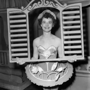 And through the square window. Chorus girl holding window frame