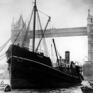 SS Picardy, moored next to Tower Bridge with a police boat in the Pool of London