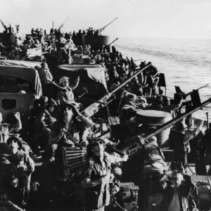 Standing by their 40 mm anti-aircraft guns, US and New Zealand soldiers scan the skies Standing by their 40 mm anti-aircraft guns, US and New Zealand soldiers scan the skies