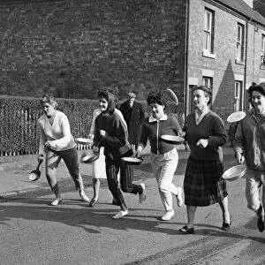 The start of the pancake race at Whittington near Lichfield which was won by Mrs Janet