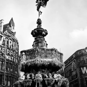 The statue of Eros in Piccadilly Circus, London covered in frozen icicles The statue of Eros in Piccadilly Circus, London covered in frozen icicles