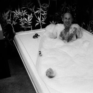Stirling Moss in bath at his new home 1978