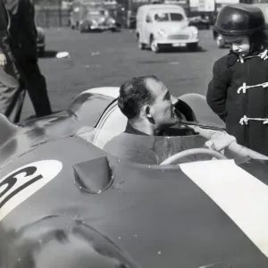 STIRLING MOSS IN HIS COOPER CLIMAX CHATS TO GEOFFREY BRABHAM, AGED 4 OF SYDNEY, AUSTRALIA STIRLING MOSS IN HIS COOPER CLIMAX CHATS TO GEOFFREY BRABHAM, AGED 4 OF SYDNEY, AUSTRALIA