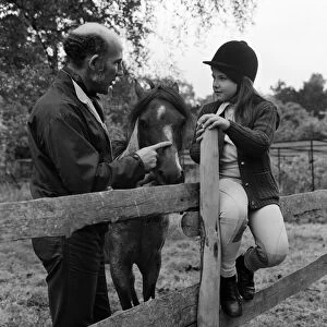 Stirling Moss and his daughter Allison (aged 7) with her horse Happy