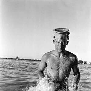 Stirling Moss getting fit by water skiing on the beach at Nassau