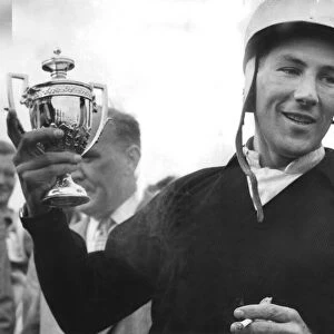 Stirling Moss holding trophy celebrating motor racing victory - September 1959