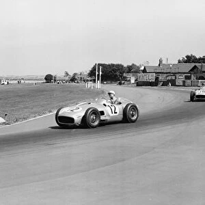 Stirling Moss leading Juan Fangio at the British Grand Prix at Aintree in Liverpool 1955