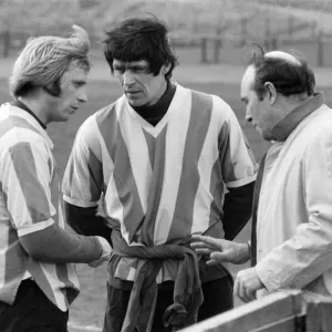Stoke City players receive some last minute instructions from manager Tony Waddington