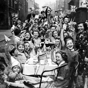 Streamers and flags are waved by residents of this Manchester street when fifty children Streamers and flags are waved by residents of this Manchester street when fifty children