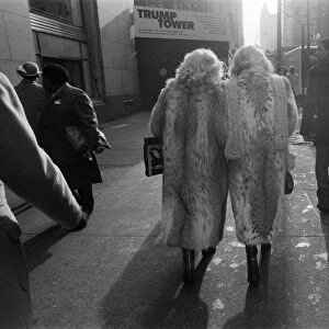 Street scene in New York, two women wearing fur coats walking down the street