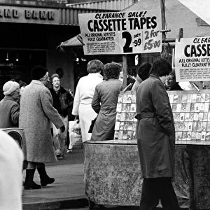 A street trader selling counterfeit cassette tapes from a stall in the Bigg Marker