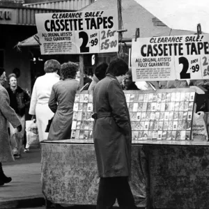 A street trader selling counterfeit cassette tapes from a stall in the Bigg Marker
