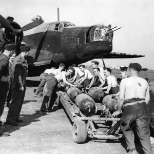 Stripped to the waist, RAF ground crews in North Africa bomb up Stripped to the waist, RAF ground crews in North Africa bomb up