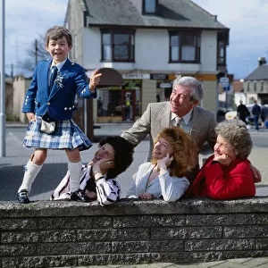 Stuart Anderson April 1989 child Andy Stewart impersonator standing on a wall watched by
