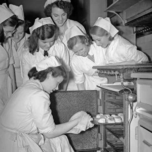 Students of Elizabeth Newcomen School in Southwark, London gather round the oven to see