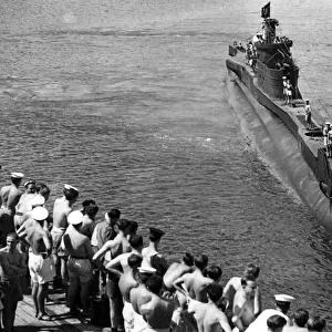 Back from a successful patrol in Far Eastern waters, a British submarine arrives back at