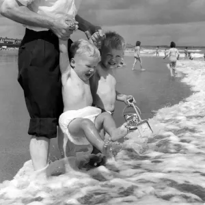 Summer Weather Scenes - Sunbathing Two young children enjoy splashing around in