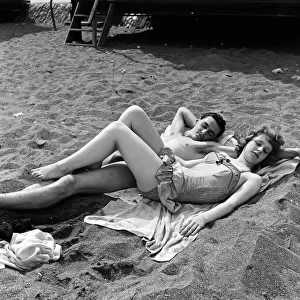 The sunbathing couple of youngsters are Mike Gardner, 19, a motor mechanic